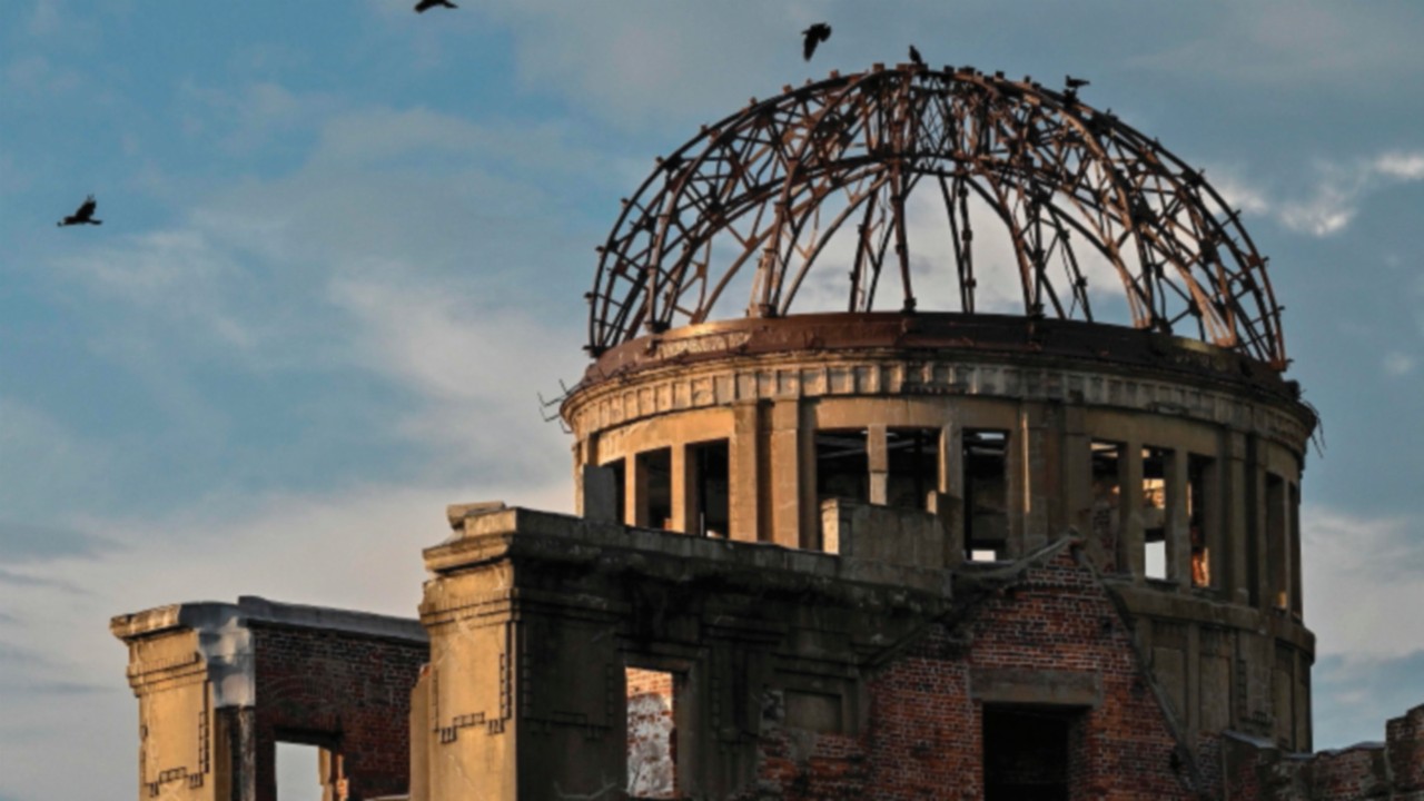 Crows fly around the top of the Atomic Bomb Dome on the eve of the 80th anniversary of the world's ...