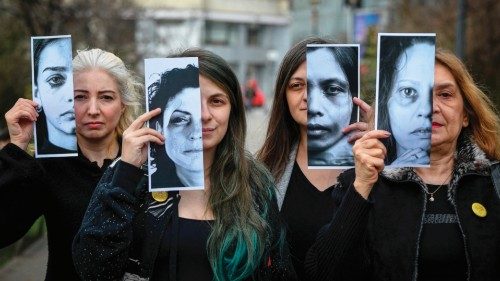 Activists of the 'Declic' movement for women's rights hold printed half face pictures showing ...
