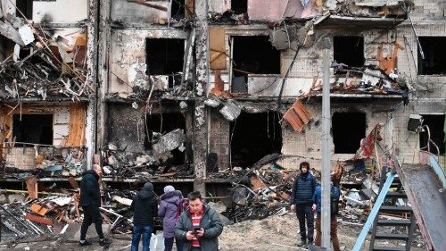 People gather in front of a damaged residential building at Koshytsa Street, a suburb of the ... People gather in front of a damaged residential building at Koshytsa Street, a suburb of the ...