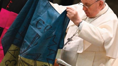 Pope Francis holds a flag of Ukraine that comes from the city of Bucha, one of the areas around ...