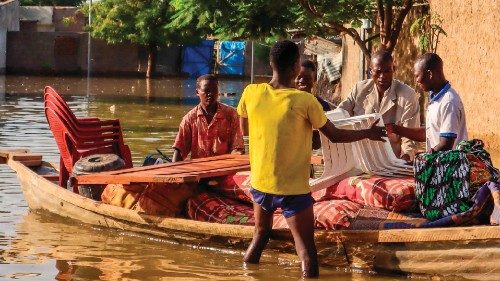 Residents try to salvage items from houses submerged by floods in N'Djamena on October 18, 2022. - ...