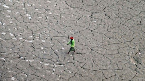 TOPSHOT - A man walks along a dry river bed on the banks of the river Ganges, in Prayagraj, on ...