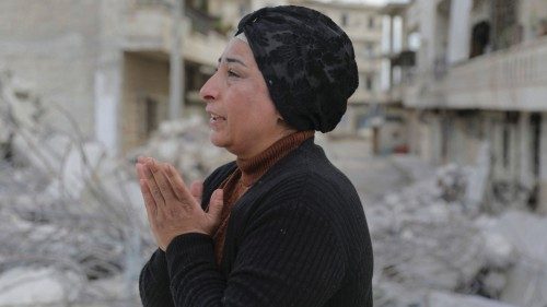 Intisar Sheikho, reacts as she stands on rubble of the building where her brother Musheer and his ...