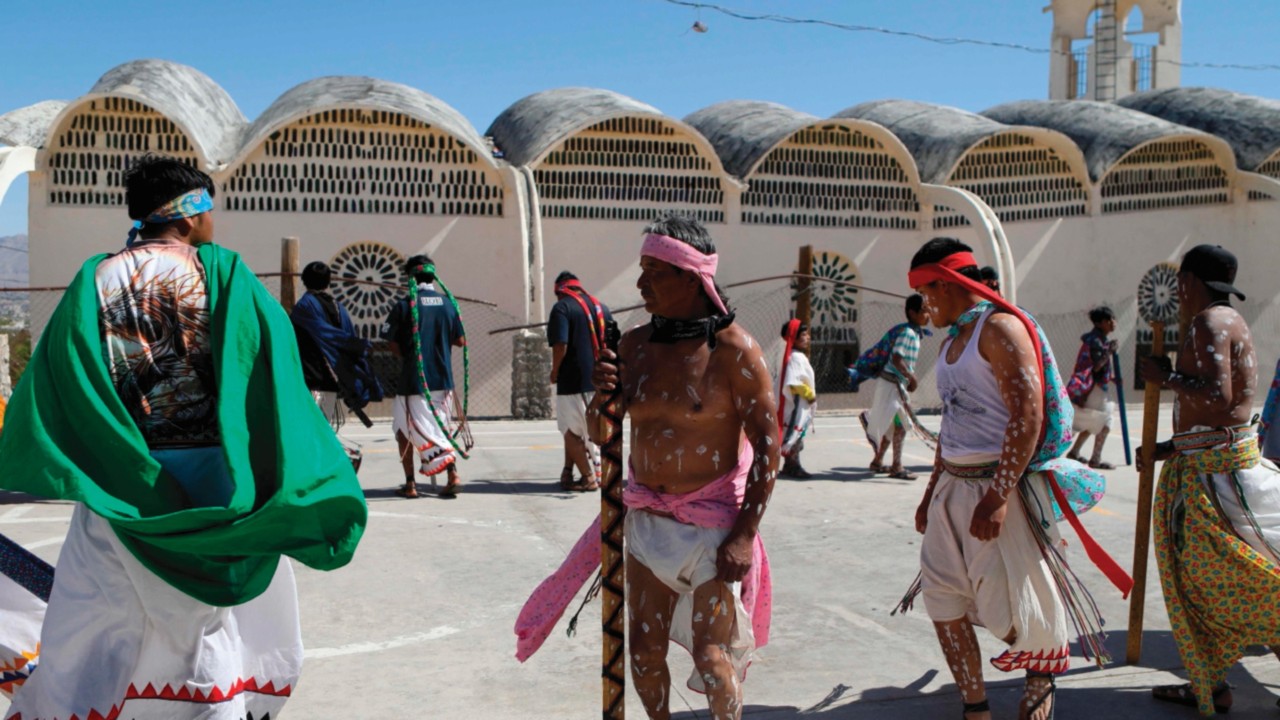 Raramuri indigenous people dressed in their traditional costumes participate in the Holy Week ...