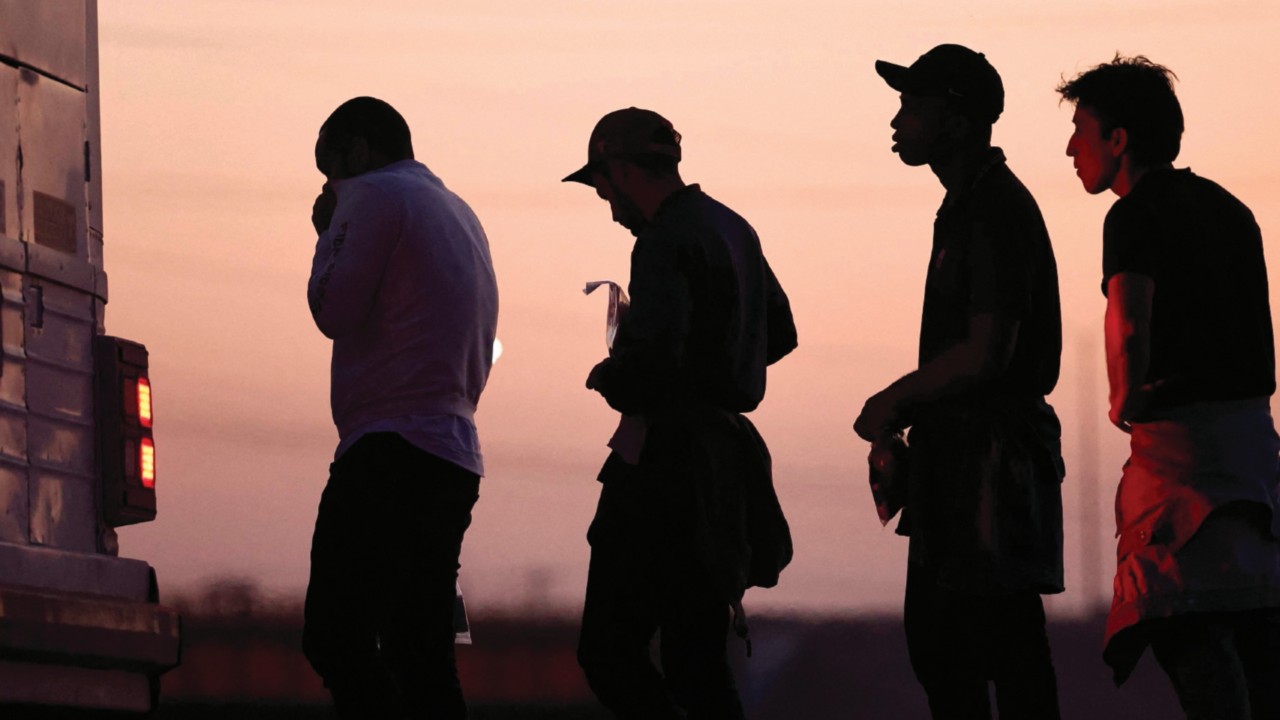 YUMA, ARIZONA - MAY 11: Immigrants seeking asylum, wait to board a bus to a U.S. Border Patrol ...