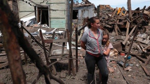 TOPSHOT - Residents survey the remains of their home in the aftermath of a Russian attack on ...