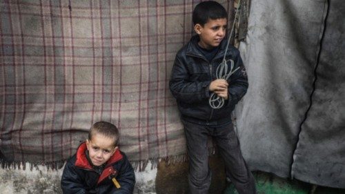 epa11177497 Internally displaced Palestinian children stand next to their families' shelters at a ... epa11177497 Internally displaced Palestinian children stand next to their families' shelters at a ...
