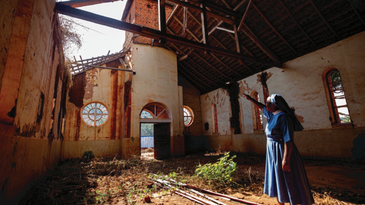 Sister Magdalena of the Divine Savior showing a semi-destroyed parish of Kindimba village (Mbinga), ...