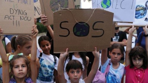 FILE PHOTO: Children hold placards during a global climate change strike rally in Nicosia, Cyprus ...