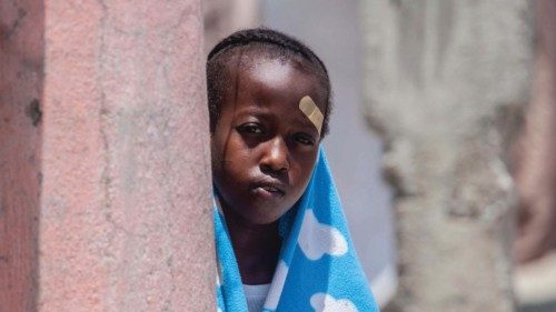 A boy looks on at a camp for people who lost their home during the August 14 earthquake in Les ...