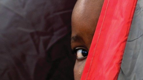 TOPSHOT - A Haitian boy peers from inside a tent at the Terraza Fandango shelter, in Ciudad Acuna, ...