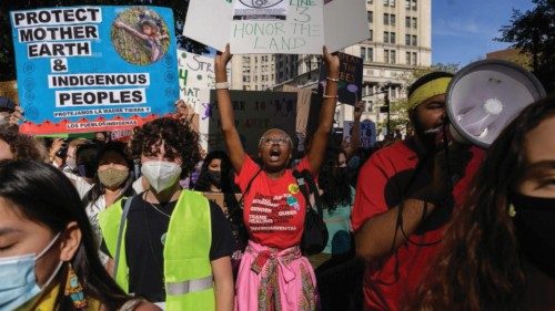 Climate activists hold placards and shout slogans as they attend a march as part of a 'Global Youth ...