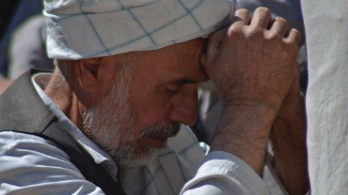 A man mourns the death of his relative at a graveyard in Kandahar on October 16, 2021, a day after ...