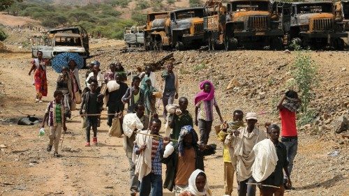 FILE PHOTO: Villagers return from a market to Yechila town in south central Tigray walking past ...