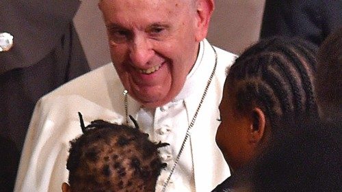 Pope Francis greets a woman holding a child after an ecumenical prayer with migrants at the Roman ...