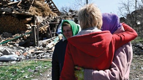 Local residents react in front of destroyed houses in the village of Korolivka, Kyiv region on April ...