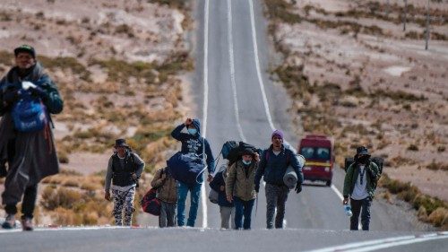(FILES) In this file photo taken on September 23, 2021, Venezuelan migrants walk towards Iquique ...