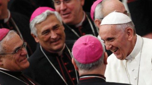 Pope Francis smiles as he greets bishops as he arrives for a meeting with novices at the Paul VI ...