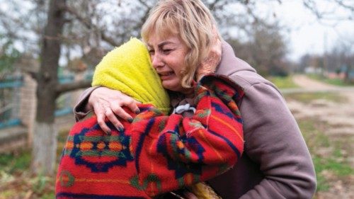 50-year school head Svitlana Striletska (R) reacts with 84-year Galina Timofievna (L), as they hug ...