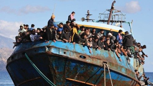 Migrants sit onboard a fishing boat at the port of Paleochora, following a rescue operation off the ...