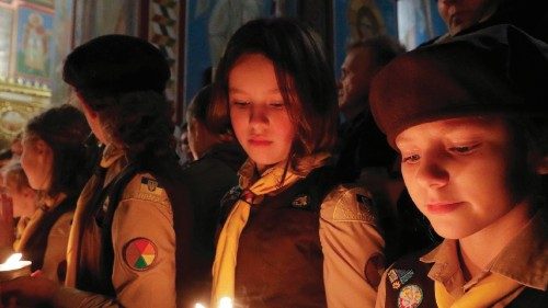 epa10361338 Members of the Plast National Scout Organization of Ukraine share the Flame of Bethlehem ...