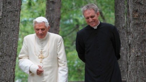 A handout photo provided by the Osservatore Romano shows Pope Benedict XVI (L) walking with his ...