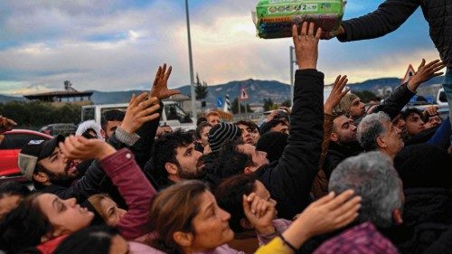 TOPSHOT - Earthquake survivors gather to collect supplies at a diaper distribution in Hatay on ...