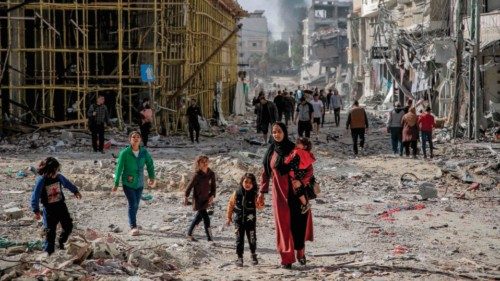 TOPSHOT - Palestinians walk amid the rubble of destroyed buildings in Gaza City on the northern Gaza ... TOPSHOT - Palestinians walk amid the rubble of destroyed buildings in Gaza City on the northern Gaza ...