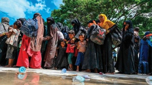 Newly-arrived Rohingya refugees wait to board trucks to transfer to a temporary shelter after ... Newly-arrived Rohingya refugees wait to board trucks to transfer to a temporary shelter after ...