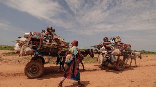 FILE PHOTO: A Sudanese woman, who fled the conflict in Murnei in Sudan's Darfur region, walks beside ... FILE PHOTO: A Sudanese woman, who fled the conflict in Murnei in Sudan's Darfur region, walks beside ...