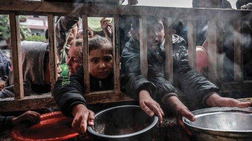 Displaced Palestinian children gather to receive food at a government school in Rafah in the ... Displaced Palestinian children gather to receive food at a government school in Rafah in the ...