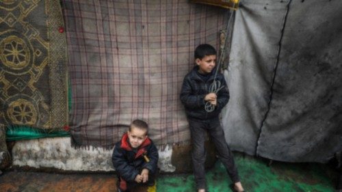 epa11177497 Internally displaced Palestinian children stand next to their families' shelters at a ... epa11177497 Internally displaced Palestinian children stand next to their families' shelters at a ...