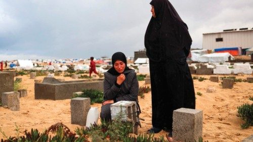 A woman cries over the grave of a loved one at the start of the Eid al-Fitr festival, marking the ... A woman cries over the grave of a loved one at the start of the Eid al-Fitr festival, marking the ...