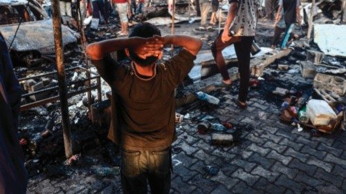 EDITORS NOTE: Graphic content / A Palestinian boy gestures as people check the destruction following ...