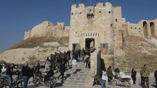 People walk at Aleppo's ancient citadel, after the Syrian army said that dozens of its soldiers had ... People walk at Aleppo's ancient citadel, after the Syrian army said that dozens of its soldiers had ...
