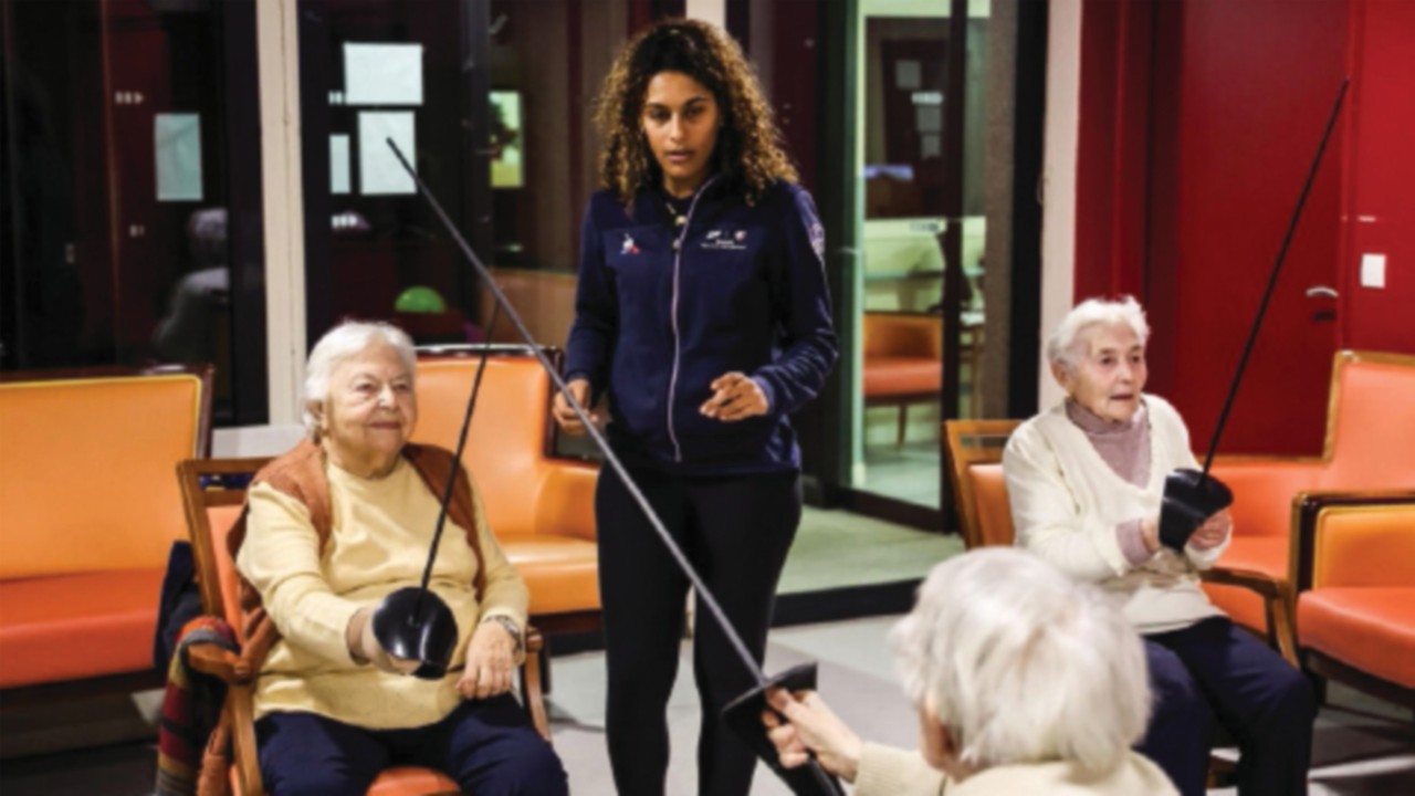 Margaux RIFKISS of France, fencers from the French Fencing Team give lessons to elderly people in ...