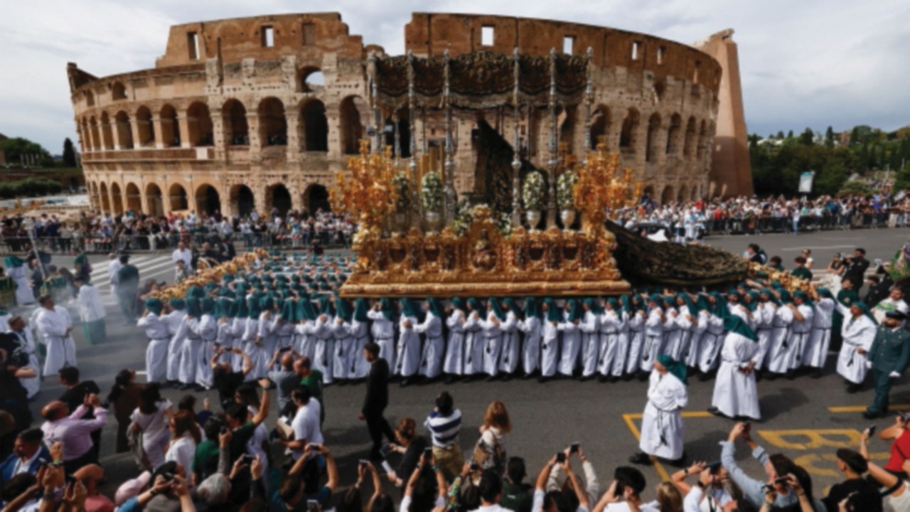 Pilgrims march near the Colosseum carrying revered statues from Europe's confraternities, during the ...