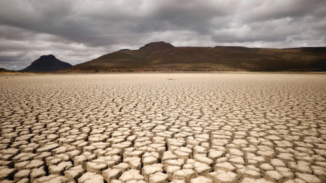 FILE PHOTO: Clouds gather but produce no rain as cracks are seen in the dried up municipal dam in ...
