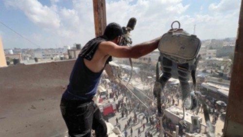 A man reacts as he holds the equipment used by Palestinian cameraman Hussam al-Masri, who was a ... A man reacts as he holds the equipment used by Palestinian cameraman Hussam al-Masri, who was a ...