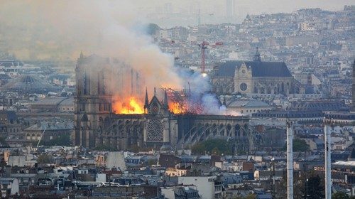 TOPSHOT - Smoke and flames rise during a fire at the landmark Notre-Dame Cathedral in central Paris ...