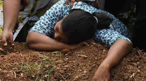A Sri Lankan woman cries during a burial service for a bomb blast victim in a cemetery in Colombo on ...