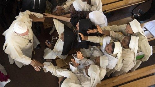 Pope Francis is greeted by nuns during his visit at the Discalced Carmelite Nuns monastery in ...