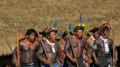 Indigenous men perform during a four-day pow wow in Piaracu village, in Xingu Indigenous Park, near ...
