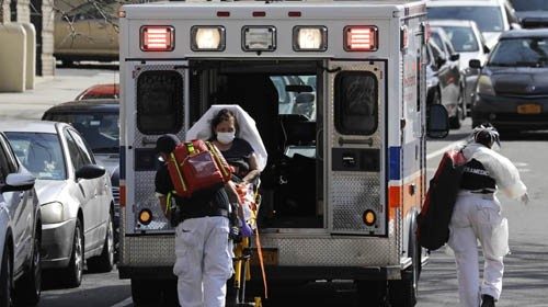 epa08349413 Paramedics take a suspected coronavirus Covid-19 patient from the Fort Washington Senior ...