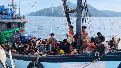 A boat carrying suspected ethnic Rohingya migrants is seen detained in Malaysian territorial waters, ...