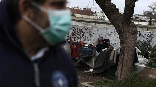 epa08350033 A member of the Doctors of the World talks with a homeless woman during a distribution ...