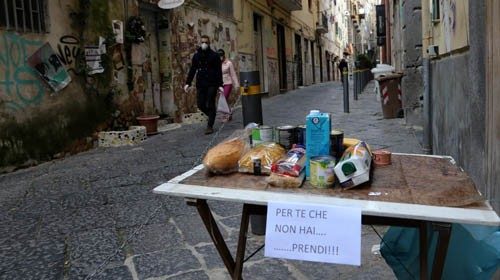 TOPSHOT - This picture shows a solidarity table ('Tavolo solidare') with a note reading 'For you who ...