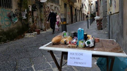 TOPSHOT - This picture shows a solidarity table ('Tavolo solidare') with a note reading 'For you who ... TOPSHOT - This picture shows a solidarity table ('Tavolo solidare') with a note reading 'For you who ...