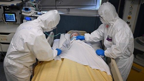 TOPSHOT - Health workers wearing protective gear take care of a patient at the level intensive care ...