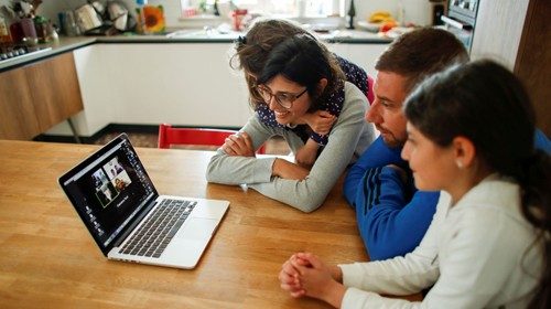 Family members talk to their relatives on a video call, during the coronavirus disease (COVID-19) ...
